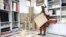 Beatrice Namawejje, marketing and sales personnel for TEXFAD, displays banana fiber products, at a showroom in Kira, Wakiso District, Uganda, Sept. 20, 2023.&nbsp;