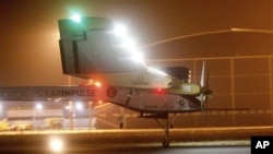 An experimental solar-powered plane, Solar Impulse, approaches to make a night landing at Rabat airport, Morocco, Tuesday, June 5, 2012 after a 20-hour trip from Madrid in the first transcontinental flight by a craft of its type. (AP Photo/Abdeljalil Boun