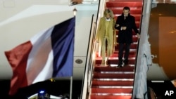 French President Emmanuel Macron with his wife Brigitte Macron arrive at Andrews Air Force Base, Md., Nov. 29, 2022, for an official state visit.