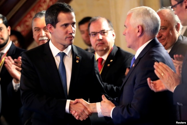 U.S. Vice President Mike Pence and Venezuelan opposition leader Juan Guaido, who many nations have recognized as the country's rightful interim ruler, shake hands during a meeting of the Lima Group in Bogota, Colombia, Feb. 25, 2019.