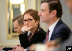 FILE - U.S. Ambassador to Ukraine Marie Yovanovitch, center, attends a meeting with Ukrainian President Petro Poroshenko (not pictured) in Kyiv, Ukraine, March 6, 2019.