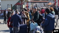 Foreign nationals arriving from Syria stand at the Lebanese Masnaa border crossing, Dec. 9, 2024. Turkey's foreign and defense ministries are coordinating evacuations of third-country nationals from Syria with logistical support of Turkish ground forces.