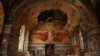 Ukrainian serviceman Gennadiy Yudin stands inside orthodox church damaged by a Russian bombing in Novoekonomichne, Ukraine, Sept. 17, 2024. 