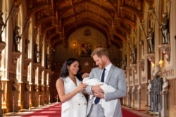 FILE - n this file photo taken on May 08, 2019 Britain's Prince Harry, Duke of Sussex (R), and his wife Meghan, Duchess of Sussex, pose for a photo with their newborn baby son, Archie Harrison Mountbatten-Windsor