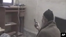 In this undated image taken from video provided by the U.S. Department of Defense, a man who the American government says is Osama bin Laden watches television in a video released on May 7, 2011