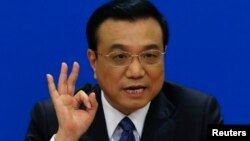 FILE - China's Premier Li Keqiang gestures as he speaks during a news conference, after the closing ceremony of the Chinese National People's Congress (NPC) at the Great Hall of the People, in Beijing, March 13, 2014.