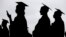 FILE - New graduates line up before the start of the Bergen Community College commencement at MetLife Stadium in East Rutherford, N.J., May 17, 2018.