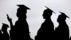 FILE - New graduates line up before the start of the Bergen Community College commencement at MetLife Stadium in East Rutherford, New Jersey, May 17, 2018.