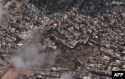 This handout satellite picture courtesy of Maxar Technologies taken on October 18, 2023, shows the aftermath of a strike on Al-Ahli hospital and the surrounding area in Gaza City, on October 17, 2023. (Photo by Satellite image ©2023 Maxar Technologies / AFP)