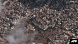FILE - This handout satellite picture courtesy of Maxar Technologies taken on Oct. 18, 2023, shows the aftermath of a strike on Ahli Arab Hospital and the surrounding area in Gaza City, on Oct.17, 2023.