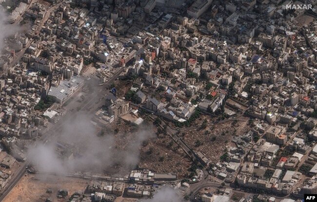 This handout satellite picture courtesy of Maxar Technologies taken on October 18, 2023, shows the aftermath of a strike on Al-Ahli hospital and the surrounding area in Gaza City, on October 17, 2023. (Photo by Satellite image ©2023 Maxar Technologies / AFP)