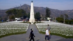 FILE - Visitors walk around a memorial for victims of COVID-19 at the Griffith Observatory, Nov. 19, 2021, in Los Angeles. The U.S. death toll from COVID-19 had topped 882,000 as of late Jan. 28, 2022, according to Johns Hopkins.