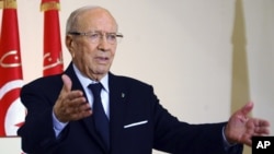 FILE - Tunisian President Beji Caid Essebsi says he and other former officials of the Zine El-Abidine Ben Ali regime are technocrats untainted by past abuses.
