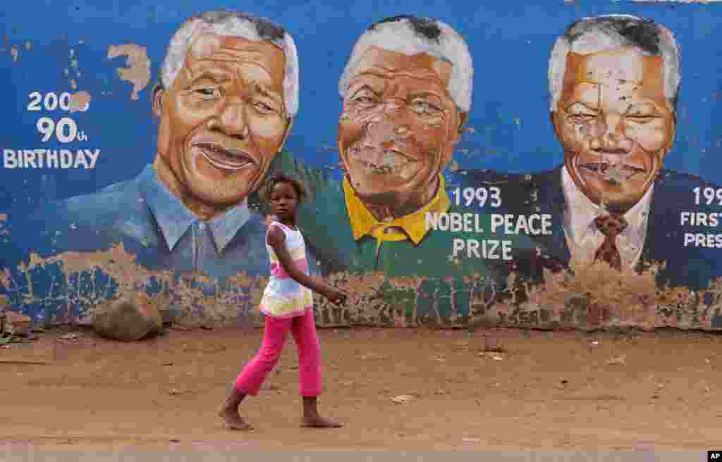 Portraits of Nelson Mandela depicted in various stages of his life in Soweto, South Africa, seen March 28, 2013. 