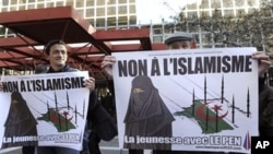 Supporters of far right-wing French politician Jean-Marie Le Pen stand in front of the courthouse in Marseille where Le Pen is accused of inciting racism in the recent anti-Muslim poster campaign by the youth wing of his party, the Front National, 05 Mar 