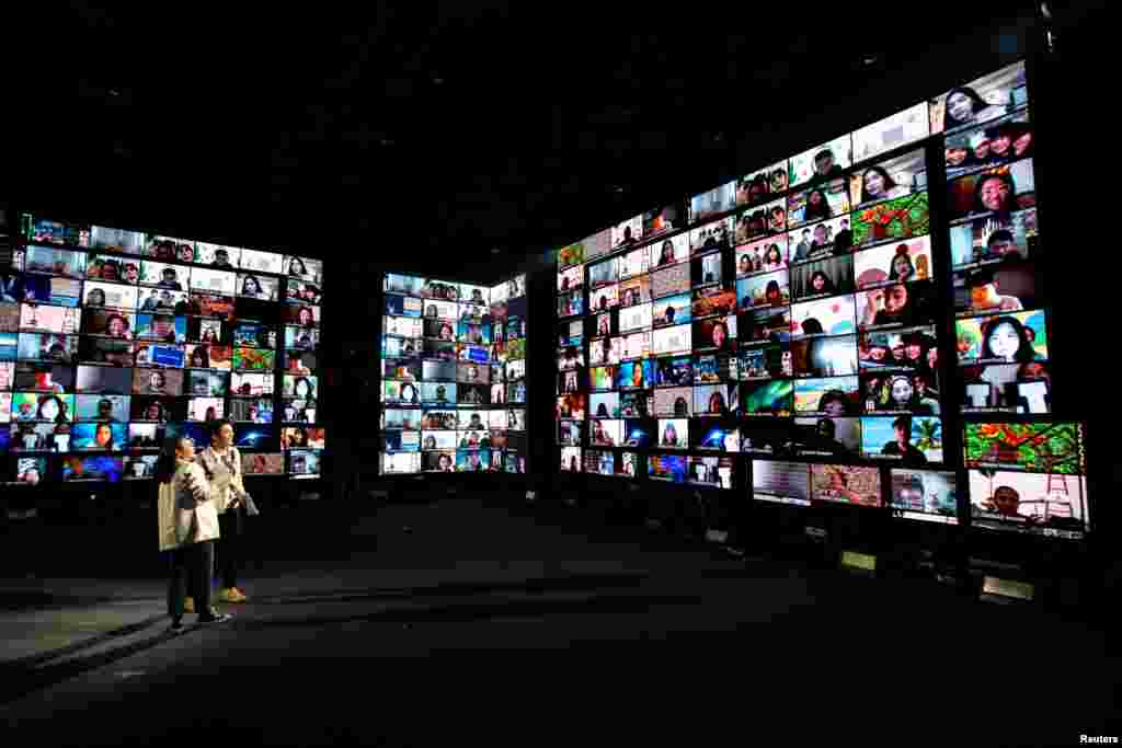 Artists perform in front of screens showing audience via the Zoom application during the first six-hour online music festival at a studio amid the spread of the coronavirus disease (COVID-19) in Bangkok, Thailand.