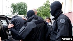 French special forces escort a suspected jihadist from a residential building in Strasbourg, May 13. 2014.