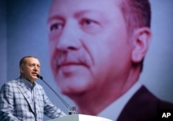 FILE - Turkey's President and leader of ruling Justice and Development Party Recep Tayyip Erdogan addresses his party members in Istanbul, June 25, 2017.