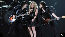 From left, Neil Perry, Kimberly Perry and Reid Perry, of musical group The Band Perry, perform at the 48th Annual Academy of Country Music Awards at the MGM Grand Garden Arena in Las Vegas, April 7, 2013.