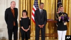 President Barack Obama awards the 2013 National Medal of Arts to Billie Tsien, second from left, and Tod Williams, left, architects, from New York, during a ceremony in the East Room at the White House in Washington, July 28, 2014. 