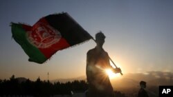 FILE - A man waves an Afghan flag during Independence Day celebrations in Kabul, Afghanistan, Aug. 19, 2019. 