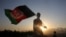 FILE - A man waves an Afghan flag during Independence Day celebrations in Kabul, Afghanistan, Aug. 19, 2019. 