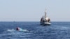 A Vietnamese sinking boat (L), which was rammed and then sunk by Chinese vessels near disputed Paracels Islands, is seen near a Marine Guard ship (R) at Ly Son island of Vietnam's central Quang Ngai province, May 29, 2014.