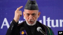 Afghan President Hamid Karzai speaks at the inauguration ceremony of the Afghan National Agriculture Science and Technology University, Saturday, Feb. 15, 2014 