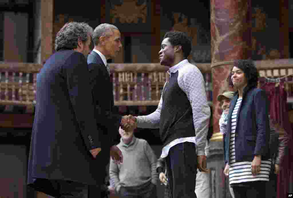 President Barack Obama, 2nd left, greets actors on stage after watching them perform Shakespeare's Hamlet at the Globe Theatre in London, April 23, 2016.