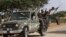 Fighters from the moderate Ahlu Sunna forces arrive at a road checkpoint outside Mareergur town, 30 km (19 miles) to the north of Dhusamareeb, in central Somalia Dec. 17, 2012. (Reuters)