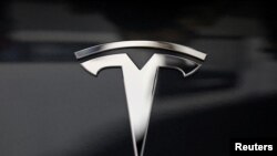 Tesla says it delivered a record of about 112,000 vehicles in the fourth quarter and about 367,500 for the full year.