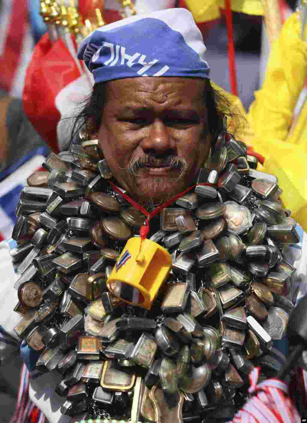 Anti-government protester has Buddhist amulets around his neck as he takes part in a rally, in Bangkok, Thailand.