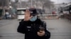 FILE - A police officer stands guard during the opening session of the National Peoples Congress in Beijing, March 5, 2021.