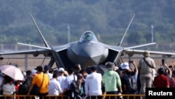 FILE - Visitors to the 15th Air Show in Zhuhai, Guangdong, China, view the Chinese Air Force's J-20 fighter jet, Nov. 12, 2024.