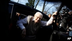 Former SS guard Oskar Groening steps out of a car as he arrives at the back entrance of the court hall prior to a trail against him in Lueneburg, northern Germany, April 21, 2015.