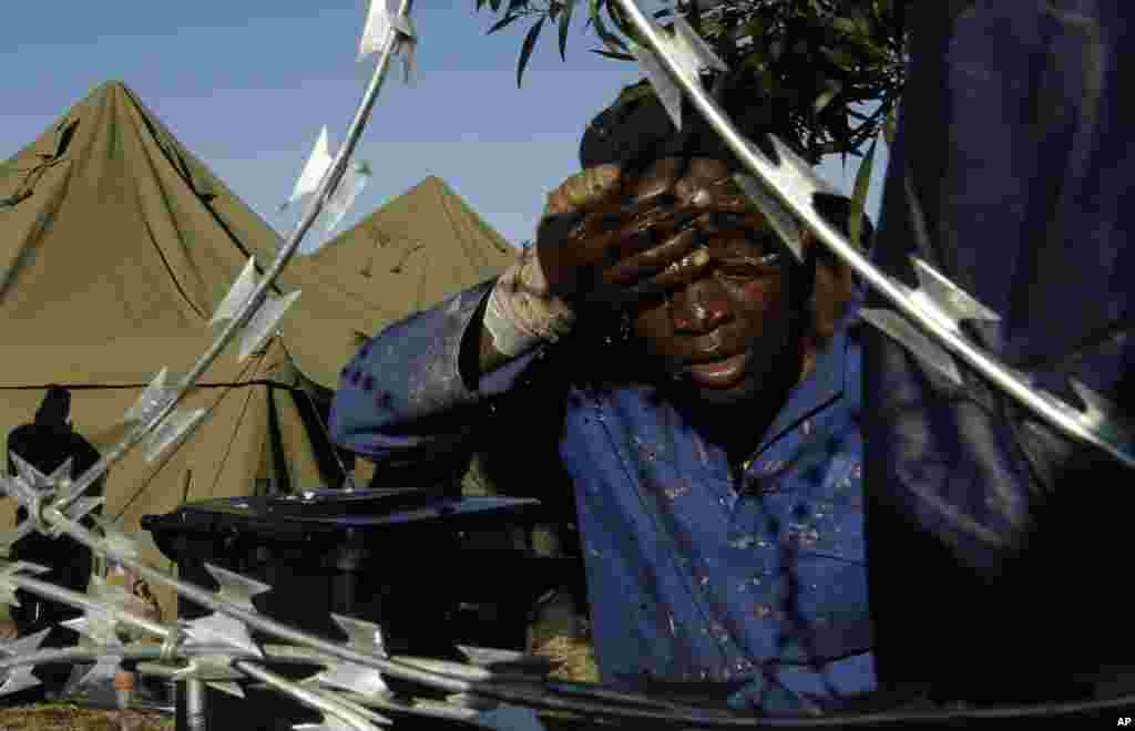 A man washes his face outside a shelter for displaced foreigners in east Johannesburg, South Africa. &nbsp;