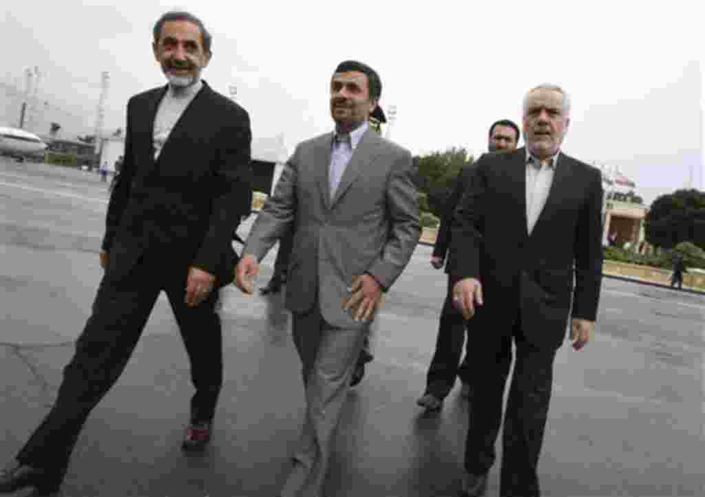 Iranian President Mahmoud Ahmadinejad, center, makes his way during a departure ceremony for him as he leaves the country for Turkey to attend an international conference in Tehran, Iran, May 9, 2011.
