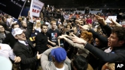 FILE - Supporters of Republican presidential candidate Donald Trump, left, face off with protesters in Chicago, March 11, 2016. A new study shows people deliberately avoid information that could threaten their beliefs. 