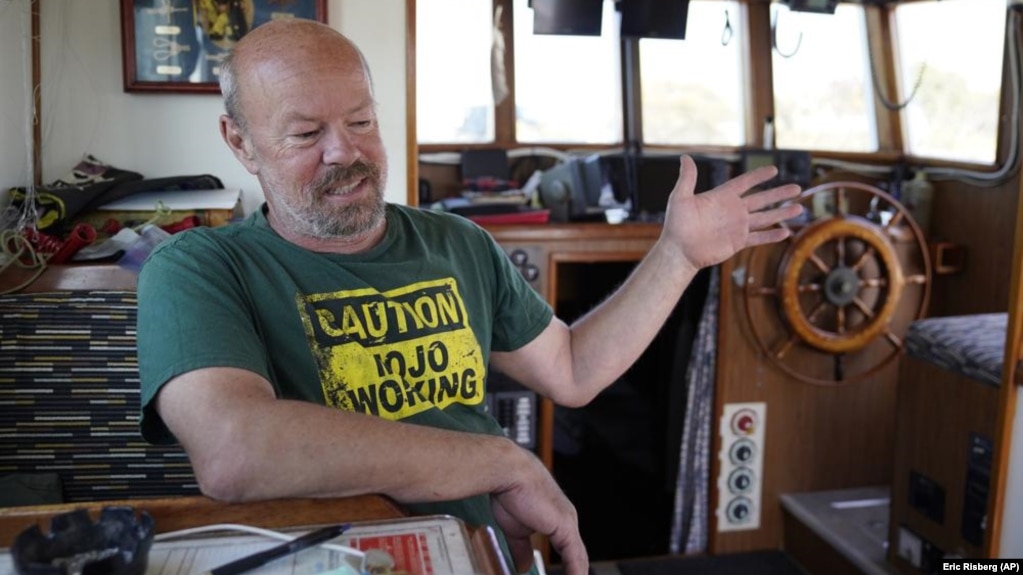  Fisherman Mike Hudson sits in the cabinet of his boat and talks about his most recent small catch of salmon at the Berkeley, Calif., Marina on Thursday, July 22, 2021.(AP Photo/Eric Risberg)