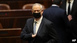 FILE - In this June 13, 2021, file photo, Israeli politician Benny Gantz stands during a Knesset session in Jerusalem.