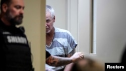 Colin Gray, 54, the father of Apalachee High School shooting suspect Colt Gray, who is charged as an adult with four counts of murder, walks in the Barrow County courthouse on the day of his and his son's first appearance, in Winder, Georgia, Sept. 6, 2024.