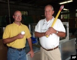 FILE - David J. Mullany, left, and his father, David A. Mullany, pose at the Wiffle Ball factory in Shelton, Conn., Aug. 7, 2003. The family business observed its 50th anniversary that year.