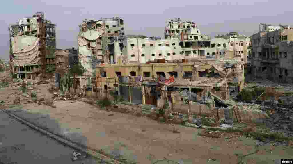 A view shows damaged buildings along a deserted street in the besieged area of Homs, Nov. 25, 2013.