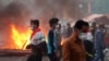 Anti-government protesters set fires and close streets during ongoing protests in Baghdad, Iraq, Nov. 9, 2019. 