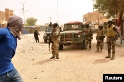 FILE - Soldiers patrol after election-related unrest, in which protesters fired shots into the air and torched vehicles in Timbuktu, Mali, July 25, 2018.