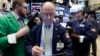 Frederick Reimer, center, works with fellow traders on the floor of the New York Stock Exchange, Jan. 27, 2017.