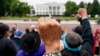 FILE - Wolf Ramerez of Houston, Texas, center, joins others with the Carrizo Comecrudo Tribe of Texas in holding up his fists as indigenous and environmental activists protest in front of the White House in Washington, Oct. 11, 2021.