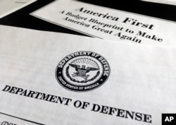 FILE - A portion of President Donald Trump's first proposed budget, focusing on the Department of Defense, and released by the Office of Management and Budget, is photographed in Washington, March 15, 2017.