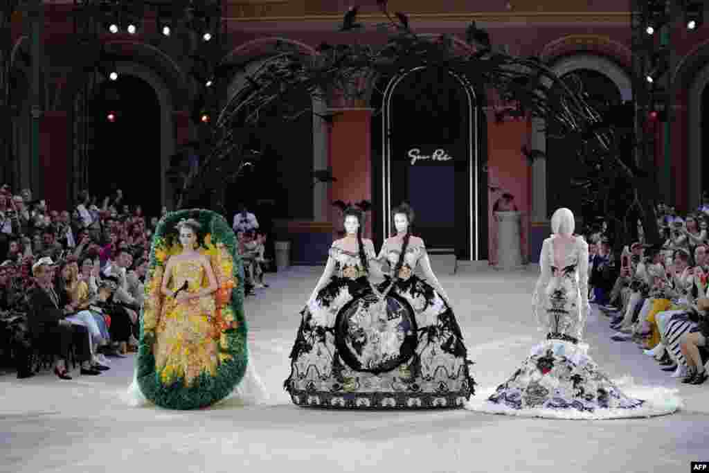Models present creations by Guo Pei at the end of the Women&#39;s Fall-Winter 2019/2020 Haute Couture collection fashion show in Paris, France, July 3, 2019.