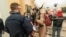 FILE - Supporters of President Donald Trump are confronted by U.S. Capitol Police officers outside the Senate Chamber inside the Capitol in Washington, Jan. 6, 2021. The Arizona man seen in the fur hat, Jacob Chansley, was taken into custody Jan. 9.